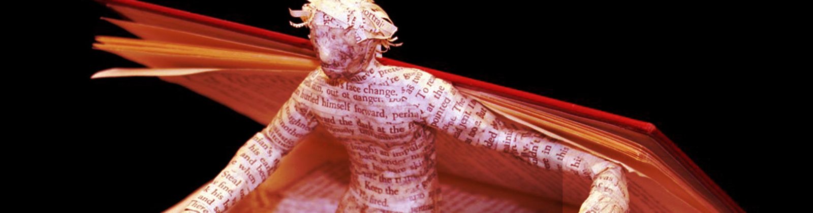 Paper figure coming out of book